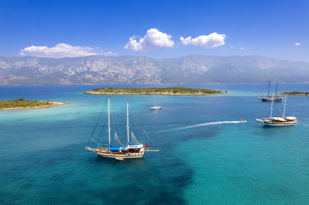 A bird's eye view of a Gulet photographed in Akyaka Sedir Island / Turkey. Gulet type boats are often preferred by crowded groups when choosing a rental yacht and boat holiday, thanks to their spacious living spaces.