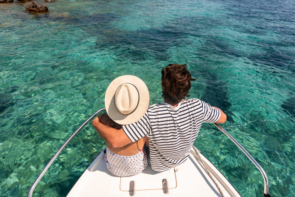 A happy couple who rented a sailboat and went on a boat vacation in Turkey.